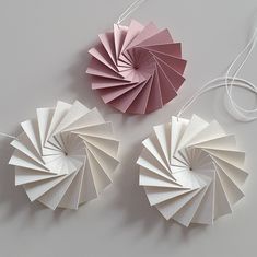 three pieces of folded paper sitting next to each other