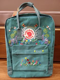 Welcome to my store and choose the perfect hand-embroidered fjallraven kanken backpack   Version & Size + Medium size: 38x27x13cm  + Big size: 42x32x13cm  - Product price includes: hand-embroidered fjallraven kanken backpack and design as shown in the picture - I can make fjallraven kanken backpack hand embroidery patterns according to your ideas - fjallraven kanken backpack will be hand embroidered with thread that won't fade when washed - fjallraven kanken backpack has a small front compartmen Kanken Flower Embroidery, Fjallraven Embroidery Diy, Embroidery Backpack Ideas, Kanken Embroidery Ideas, Summer Embroidery Ideas, Embroider Backpack, Kanken Backpack Embroidery, Ladybug Embroidery Design, Embroidered Kanken