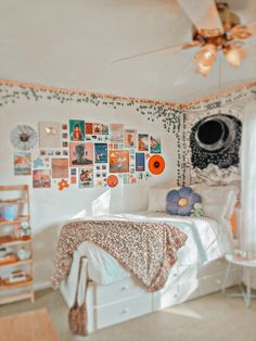 a bedroom with white walls and lots of pictures on the wall, including a bed