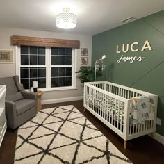 a baby's room with a white crib and green walls