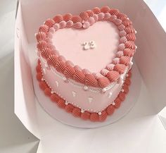 a heart shaped cake in a pink box