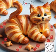 there is a cat made out of bread on a plate with paw prints around it