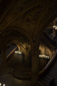 an ornate building with chandeliers and stairs