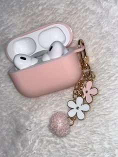 an airpods case with flowers attached to it