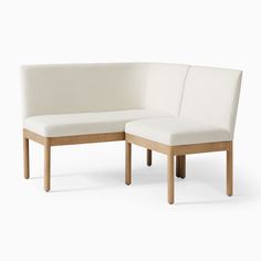 two white couches sitting next to each other on top of a white flooring