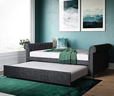 a day bed with green carpet and blue walls