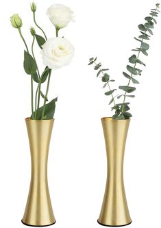 two gold vases with white flowers and greenery in them on a white background