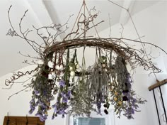 a chandelier with flowers hanging from it's ceiling