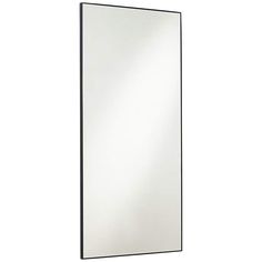 a mirror that is sitting on top of a wall next to a white wall and black frame