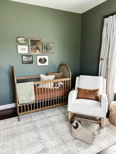 a baby's room with a crib, rocking chair and pictures on the wall