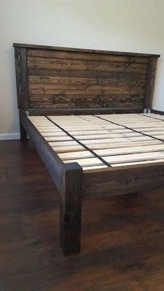 a bed frame made out of wood with no headboard or foot board on it