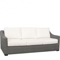 an outdoor sofa with white cushions