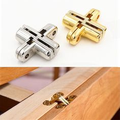 two different types of door handles and latches on the same piece of wooden furniture