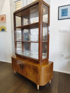 a wooden cabinet sitting on top of a hard wood floor