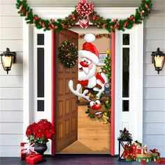 an open door decorated for christmas with santa clause on the front porch and presents around it