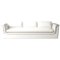 a white couch sitting on top of a white floor