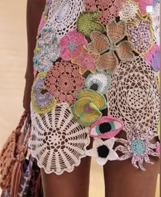 a woman's shorts with crocheted flowers on them