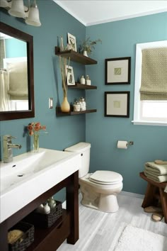 a bathroom with green walls and white fixtures