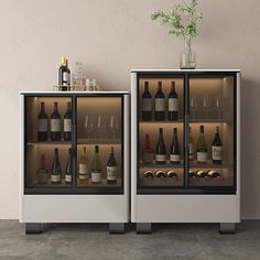 two wine coolers with bottles and glasses in them