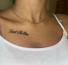 a woman with a tattoo on her chest that says, trust me one