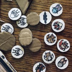 several buttons with different designs on them sitting on a table