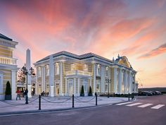 a large white building sitting on the side of a road