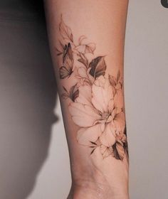 a woman's arm with flowers on it