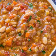 a white bowl filled with beans and carrots