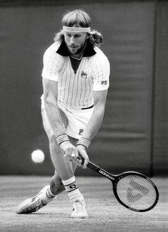 a man holding a tennis racquet on top of a tennis court