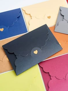 several different colored cards with hearts on the front and one has a heart in the middle