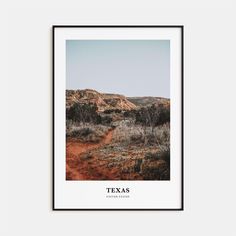 the texas landscape is framed in black and white, with an orange dirt path leading through it