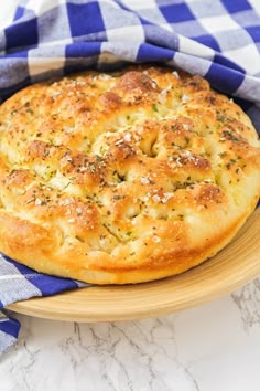 a bread dish on a plate with a blue and white checkered cloth