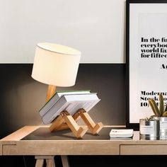 a lamp sitting on top of a wooden table next to a book and bookshelf