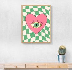 a pink heart with an eye in the center on a green and white checkered background