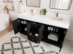 a white bathroom with two sinks and black cabinets