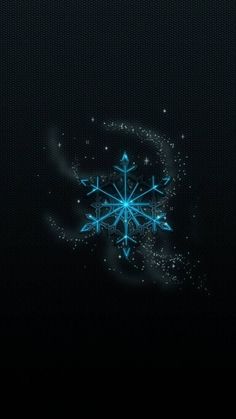 the snowflake is shining brightly in the dark night sky, and it appears to be glowing blue