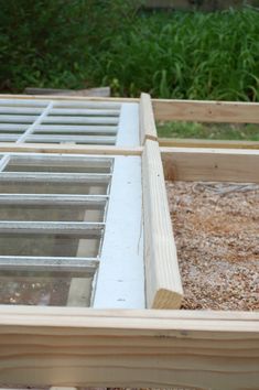 an unfinished window frame is shown in the process of being made into a planter box