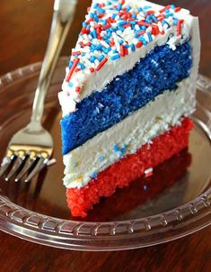 a piece of cake with red, white and blue frosting on a glass plate