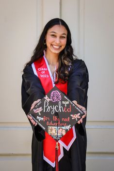 a woman wearing a graduation gown and holding a sign that says poshed for the next university