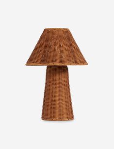 a wicker table lamp on a white background