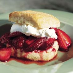 strawberry shortcake with whipped cream and strawberries on a plate