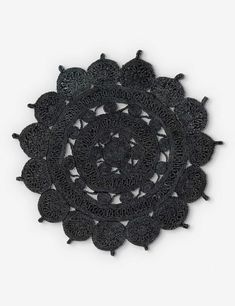 a black doily is shown on a white background