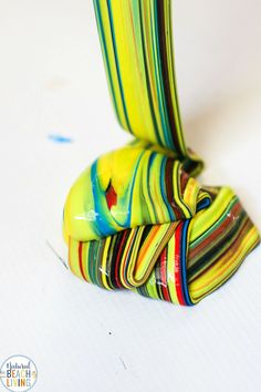 a colorful vase sitting on top of a white table