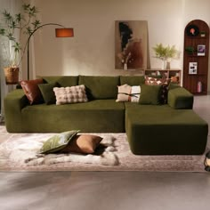 a green couch sitting on top of a rug in a living room