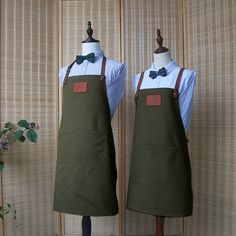 two mannequins dressed in green aprons with bow ties