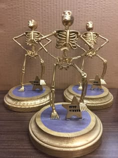 three skeleton figurines standing on top of each other