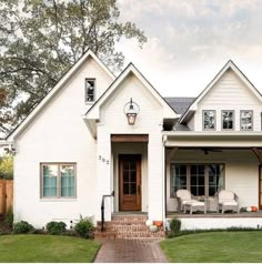 a white house with brick walkway leading to the front door