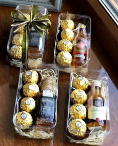 four boxes filled with different types of chocolates and bottles of alcohol sitting on a table