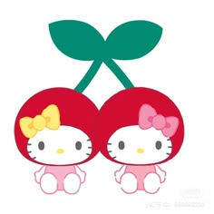 an image of two cherries with hello kitty on them and one has a bow