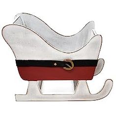 a white sleigh with red and black trimmings on the bottom is sitting in front of a white background